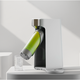 Strauss water product dispenses sparkling water into a glass