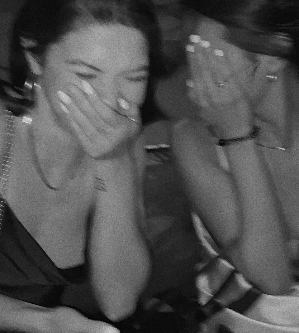 Two females laughing and covering their faces