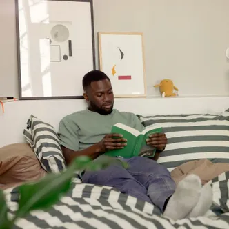 Scape resident reading in bed
