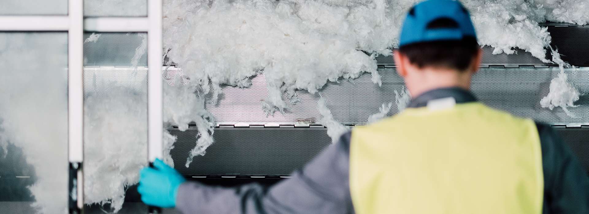 Man standing in from of fiber production