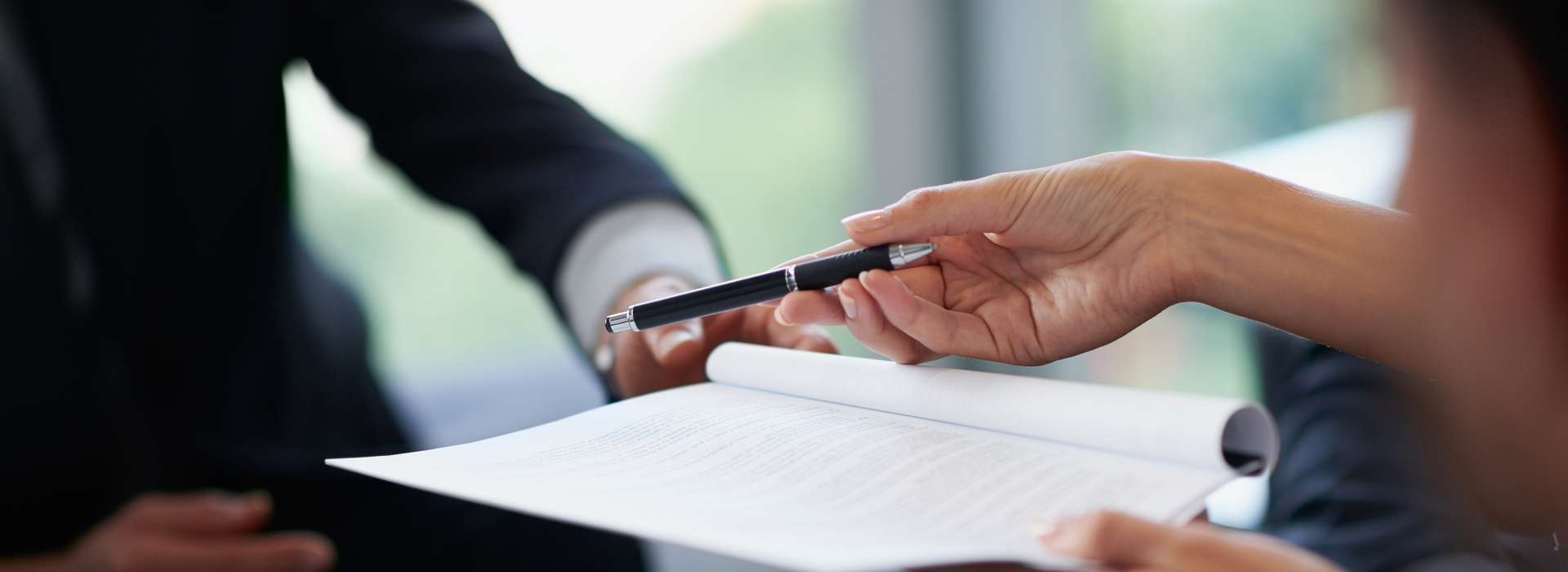 A picture of persons signing a contract