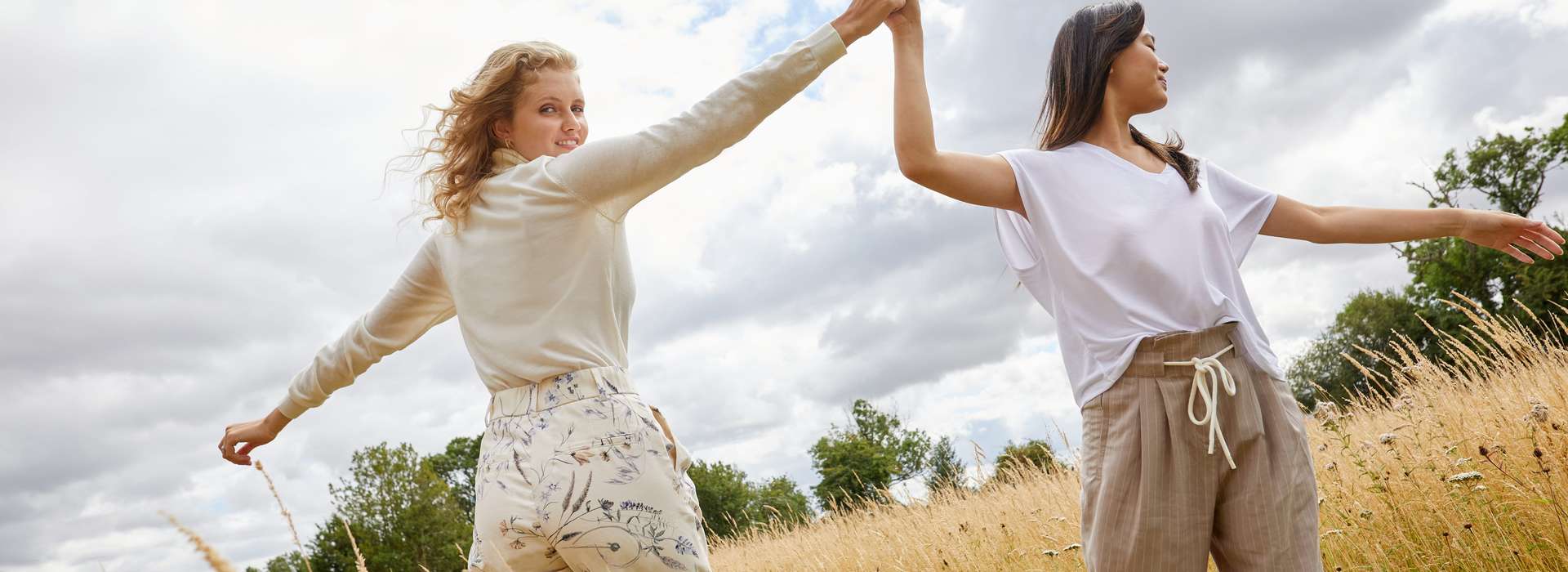 two women on a meadow in Lenzing EcoVero(TM) clothing