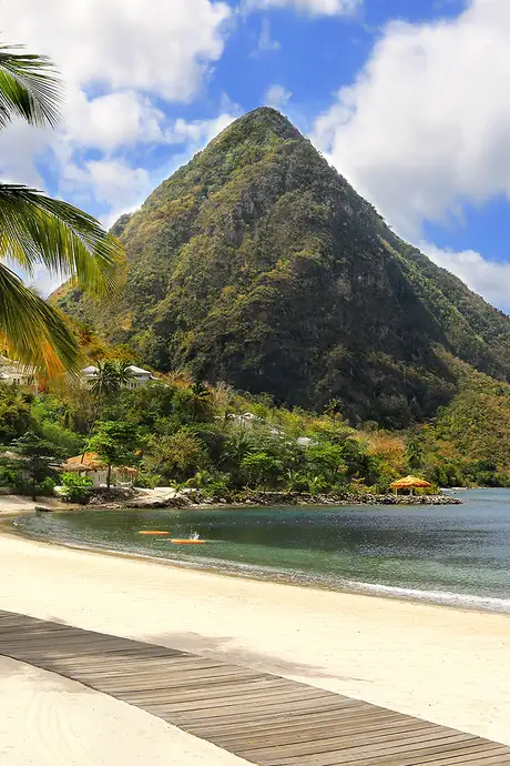 A beach in the Caribbean with a large mountain in the distance