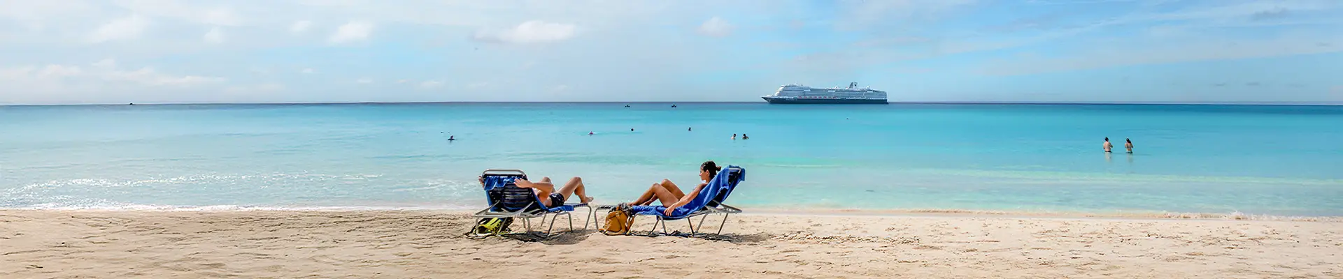 A View of two people lounging on a beach in Half Moon Cay