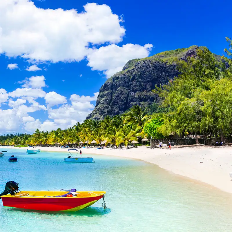 A beach with boats dotting the shore in Mauritius