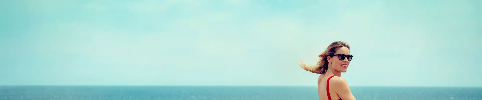 A woman standing next to a railing on a Cunard Cruise ship