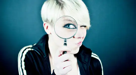 A Woman looking through a magnifying glass