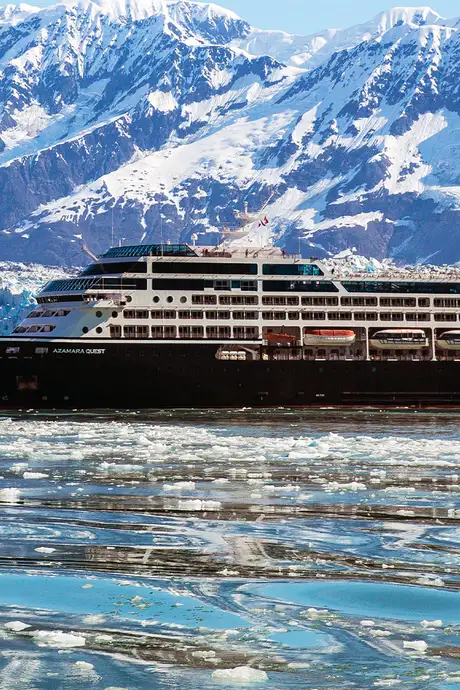 Azamara Quest at Sea with Snowy mountains and a glacier behind it
