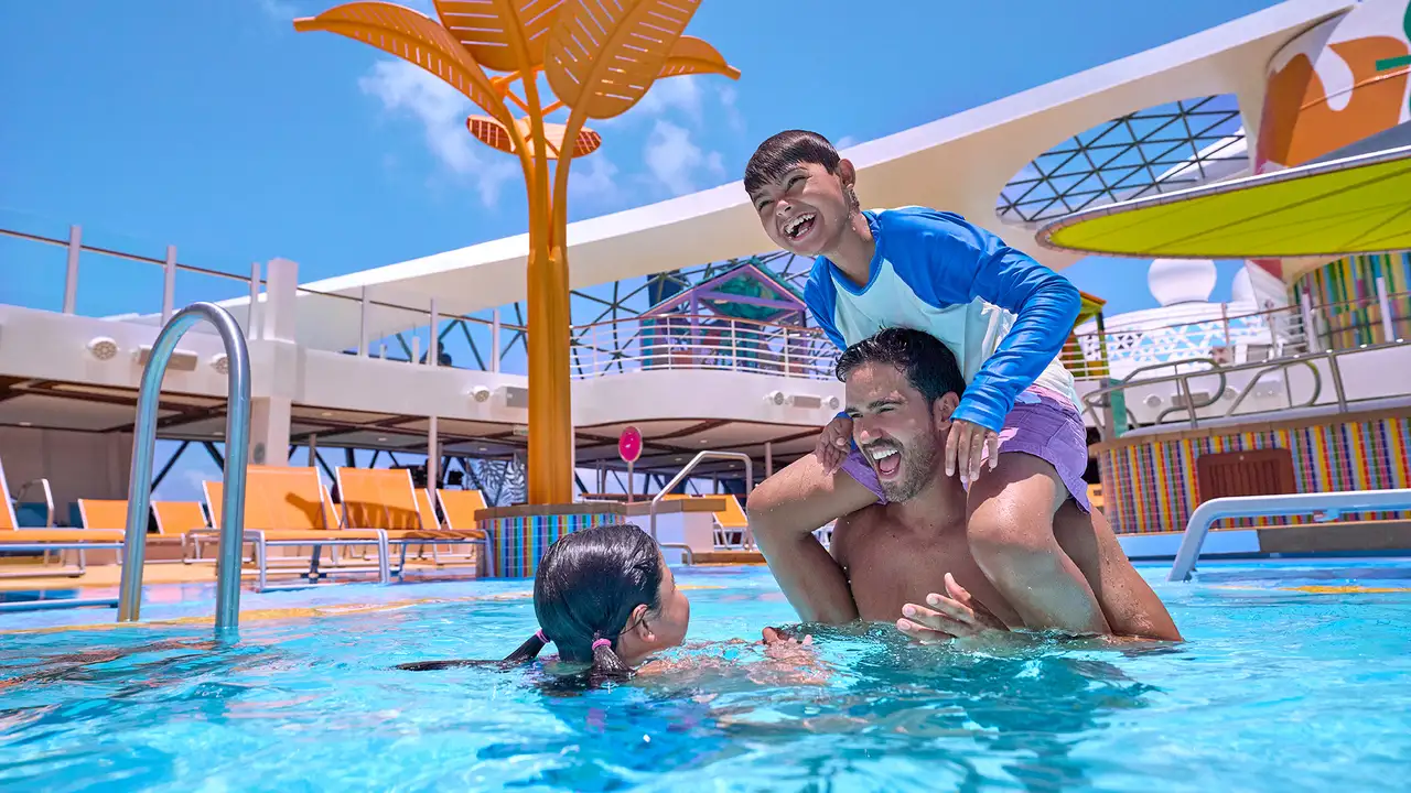 A family swimming in a pool aboard a Royal Caribbean ship