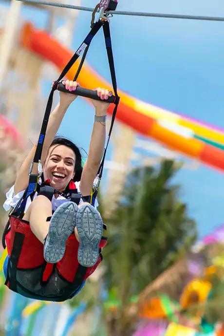 A Woman going down a Zipline on Cococay