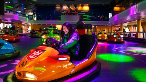 A woman driving a Bumper Car aboard a Royal Caribbean Ship