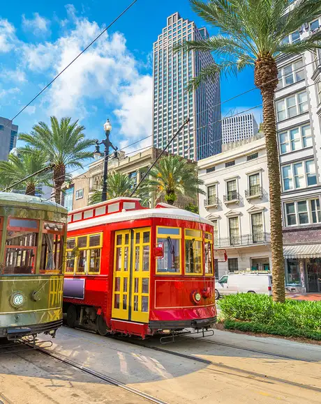 Two Colourful trams traveling through New Orleans