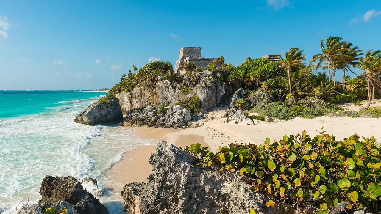 A beach in Mexico with Ruins of a castle on a hilltop