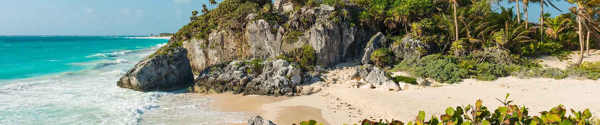A beach in Mexico with Ruins of a castle on a hilltop