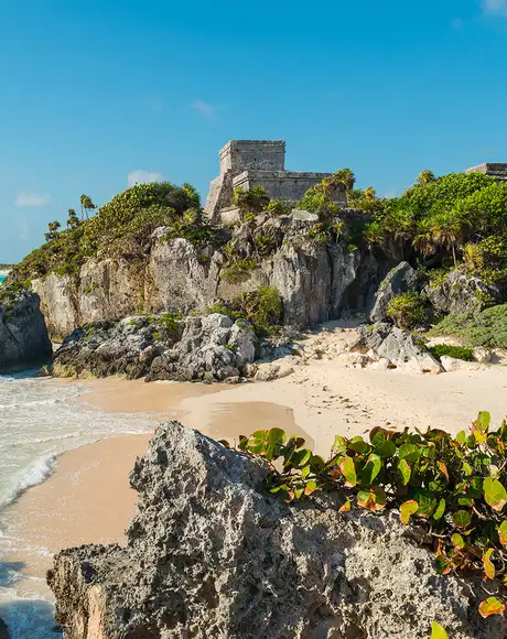 A beach in Mexico with Ruins of a castle on a hilltop