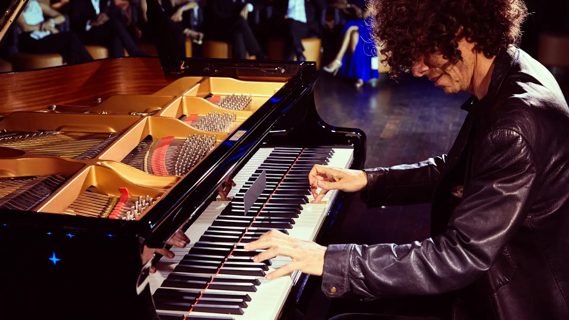 A man playing the piano on a Seabourn Ship
