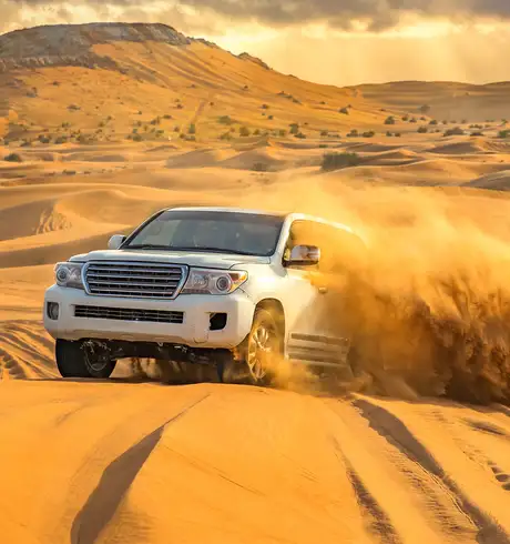 A SUV driving through a Desert in Dubai