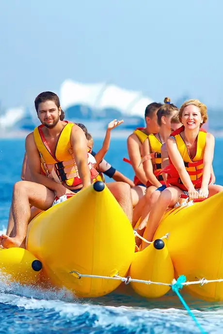 A Family riding a banana shaped boat