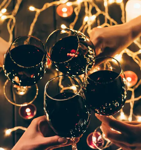 A group of friends cheering wine glasses