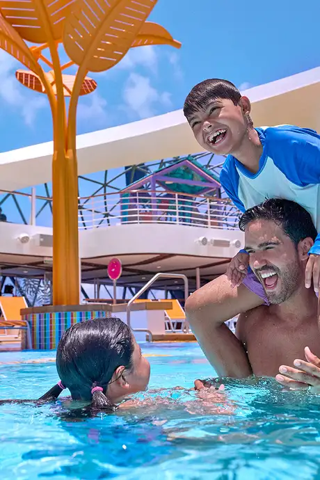 A family playing in a pool aboard a Royal Caribbean Ship