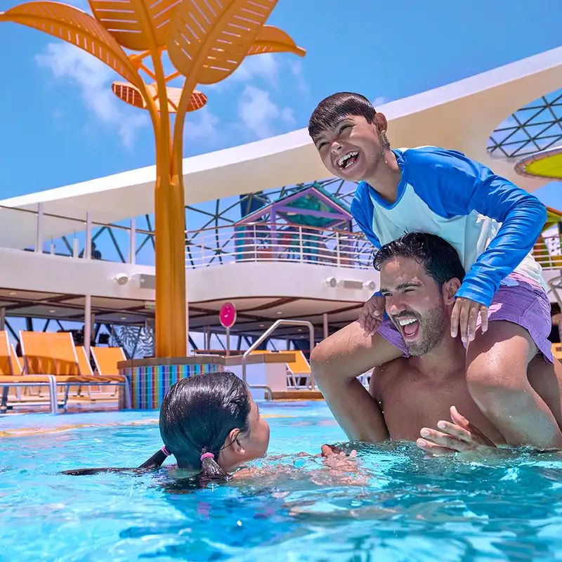A family playing in a pool aboard a Royal Caribbean Ship