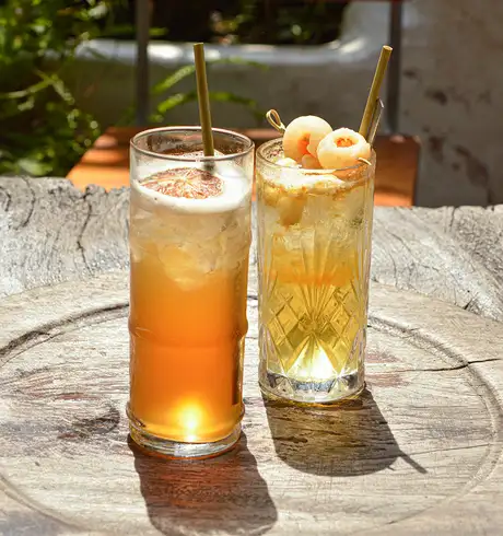 Two Cocktails served at a bar