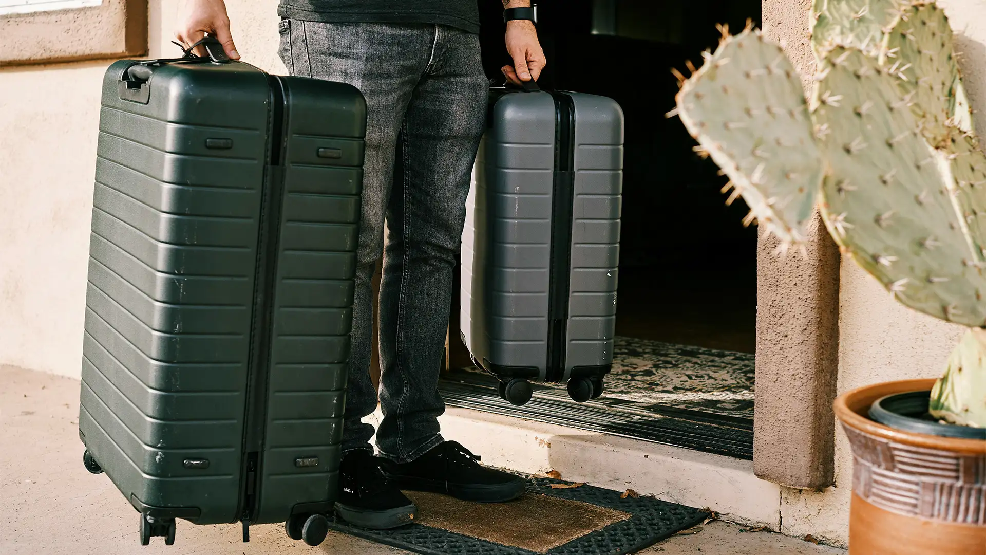 A Person holding two suitcases