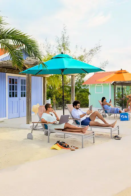 People relaxing outside of bungalows on Princess Cays