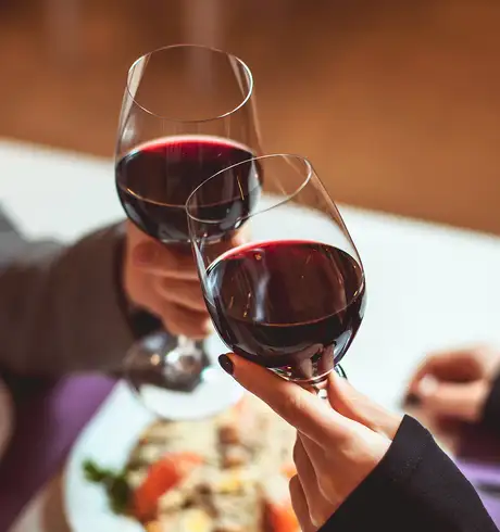 A couple cheering glasses of wine