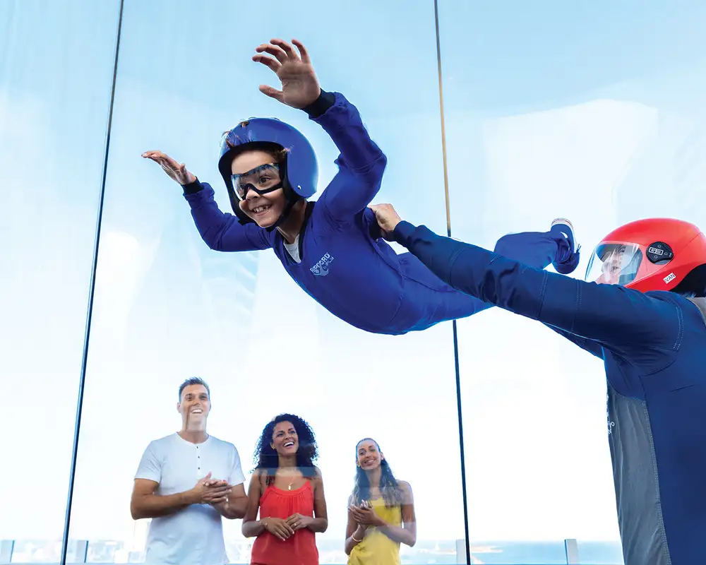 A child riding the RipCord wind chamber aboard a Royal Caribbean Ship