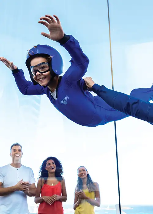 A child riding the RipCord wind chamber aboard a Royal Caribbean Ship