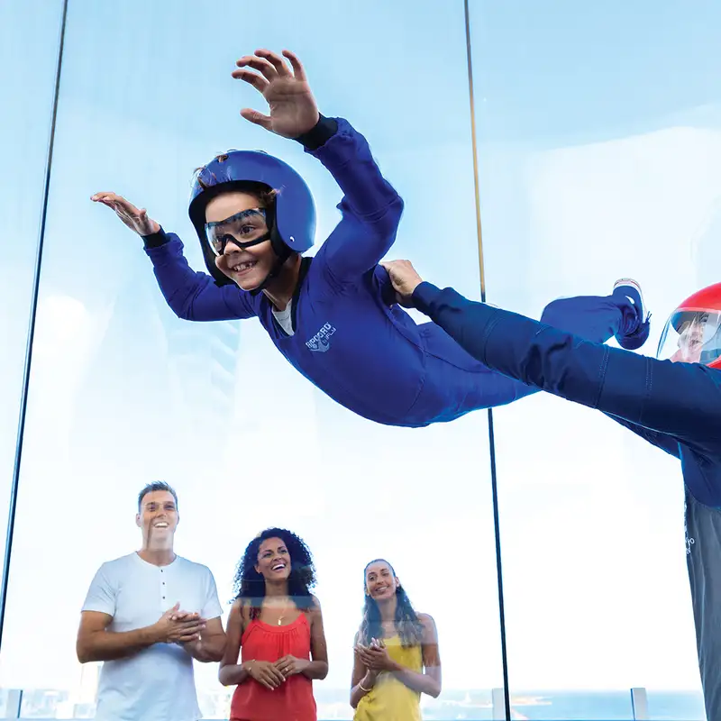 A child riding the RipCord wind chamber aboard a Royal Caribbean Ship