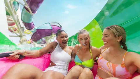 A group of friends going down a waterslide on CocoCay