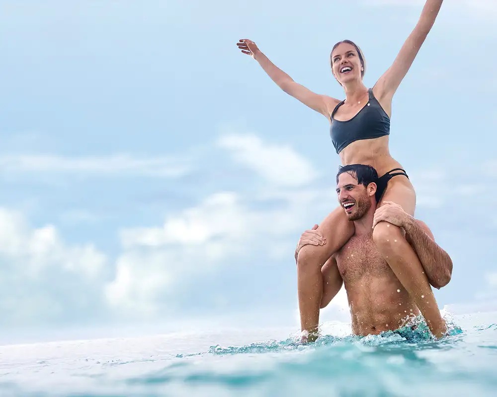 A couple in the ocean around MSC's Ocean Cay