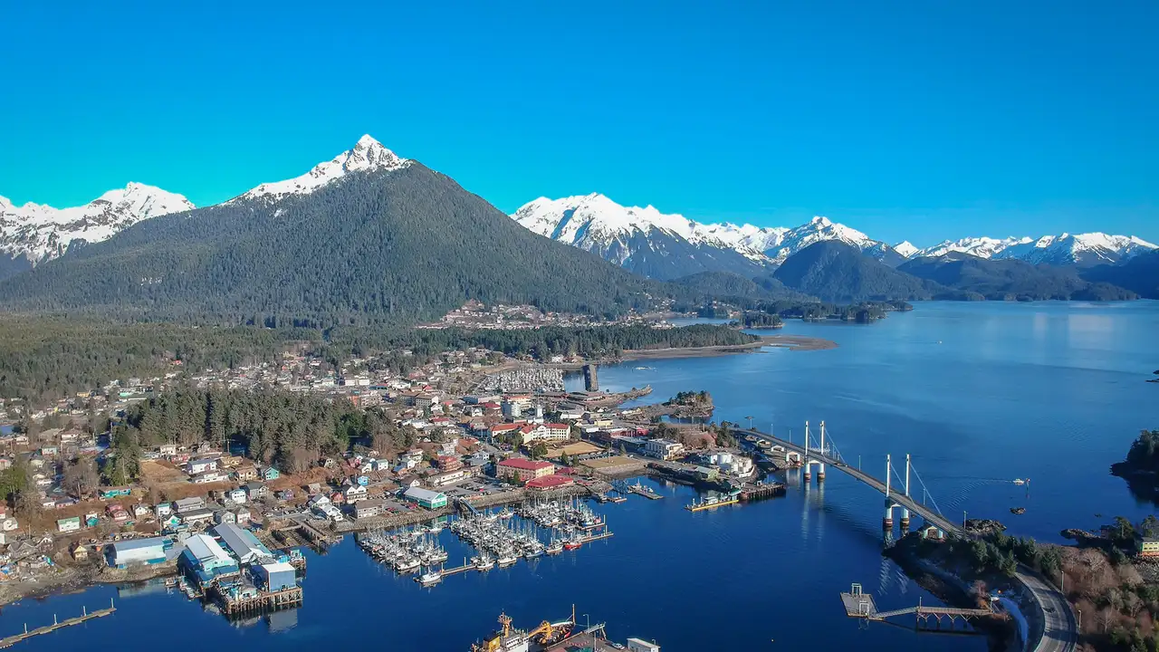 An Aerial image of Sitka, Alaska. Showing the town, the surrounding wilderness and the distant mountains