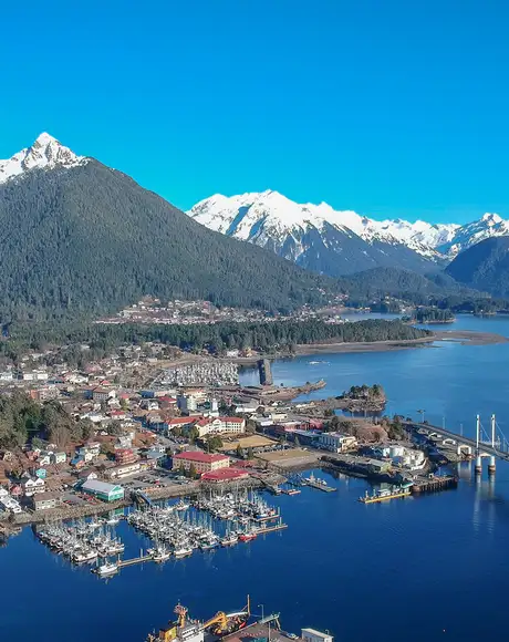 An Aerial image of Sitka, Alaska. Showing the town, the surrounding wilderness and the distant mountains