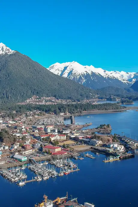 An Aerial image of Sitka, Alaska. Showing the town, the surrounding wilderness and the distant mountains