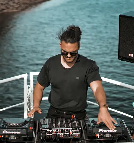 A DJ performing on a boat