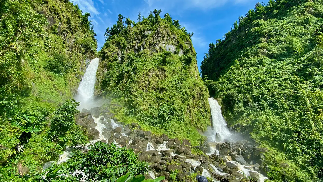A Waterfall in Dominca surrounded by greenery