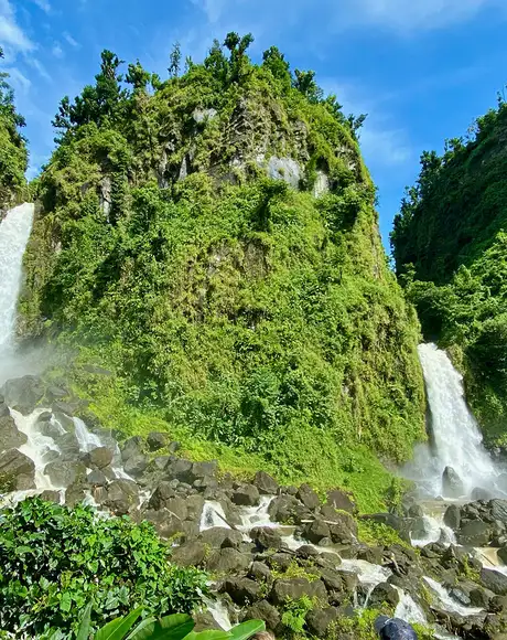 A Waterfall in Dominca surrounded by greenery