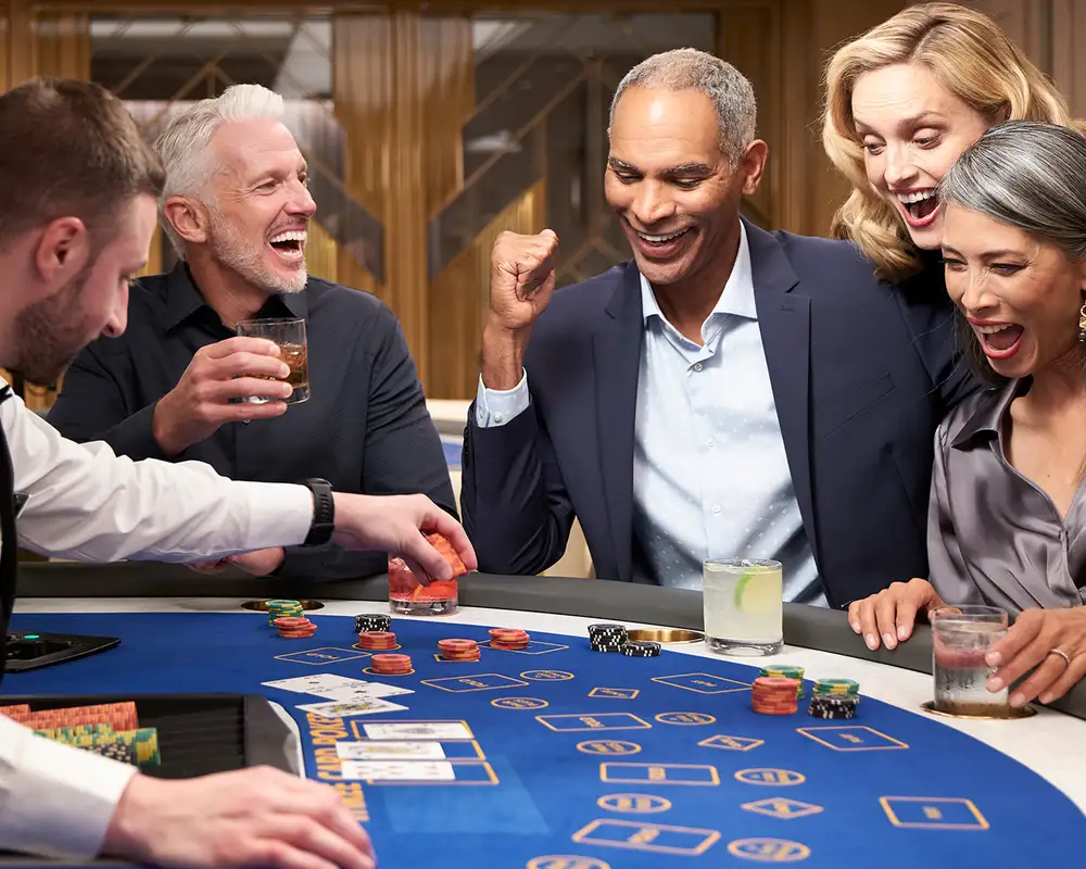 A Group of people playing blackjack in a casino aboard an Oceania Cruise Ship