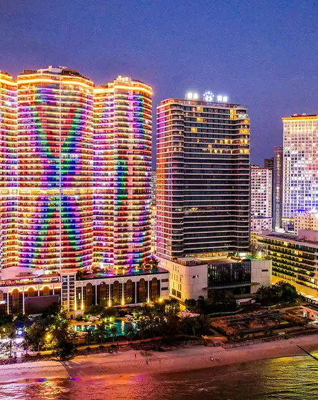 Buildings lit up at night in Sihanoukville, Cambodia