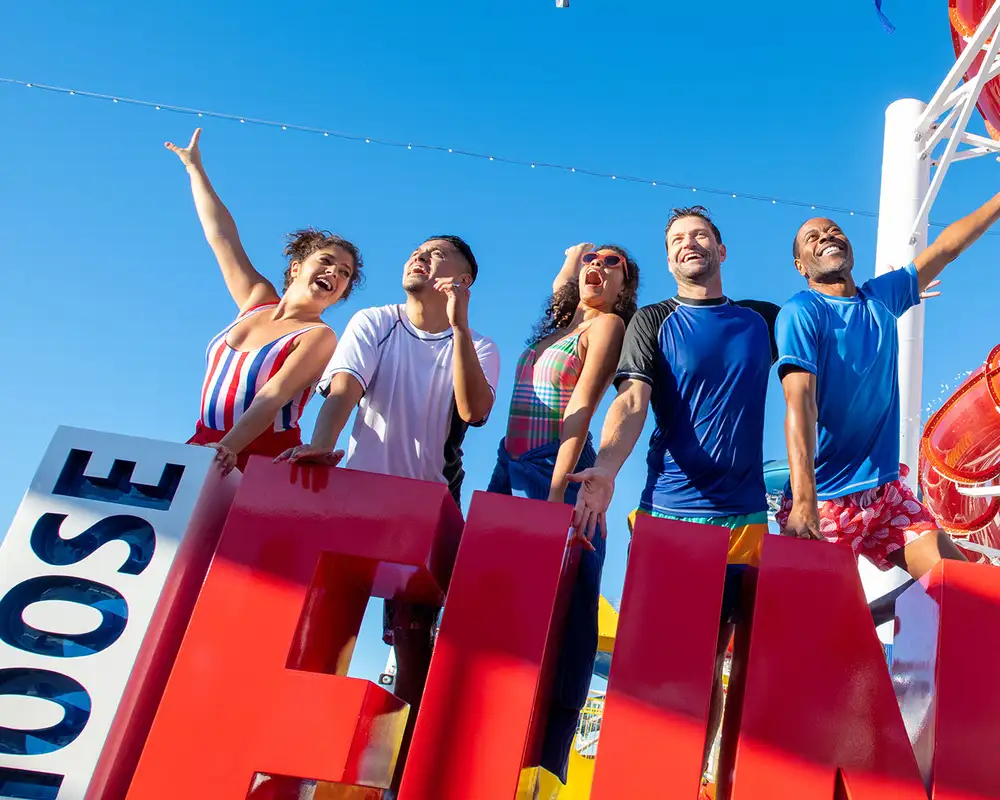 Friends cheering behind a sign that says Choose Fun