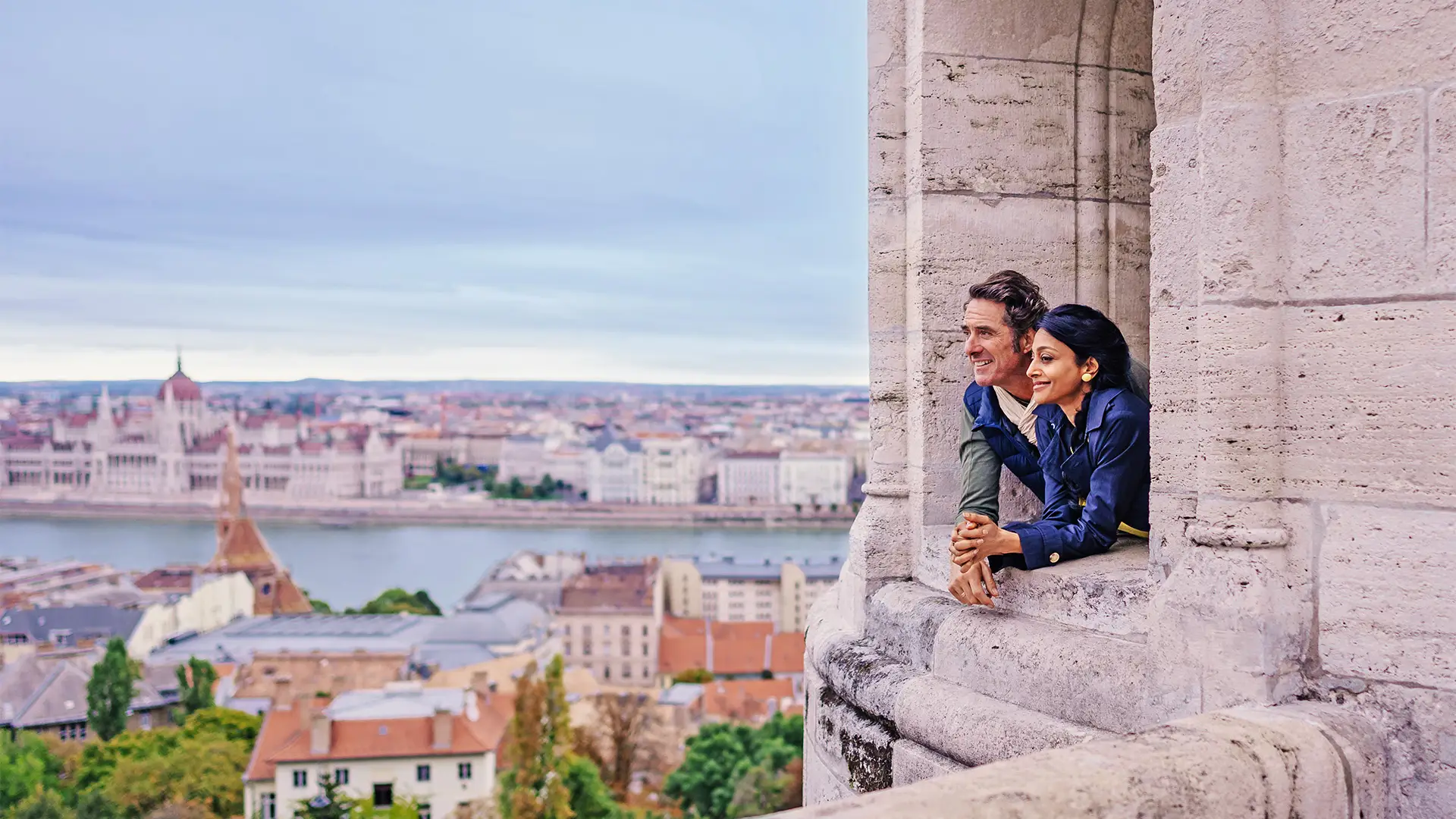 A Couple looking out of a castle window
