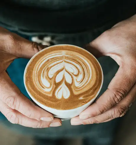 A person holding a cup of Coffee
