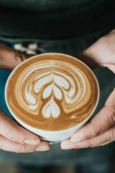 A person holding a cup of Coffee