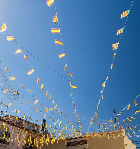 Flags flying connected between buildings for a festival
