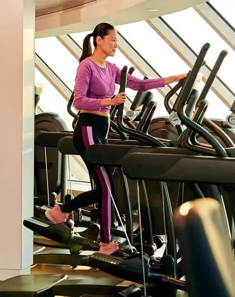 A Woman using a Crossfit Machine in a Gym aboard a Celebrity Ship