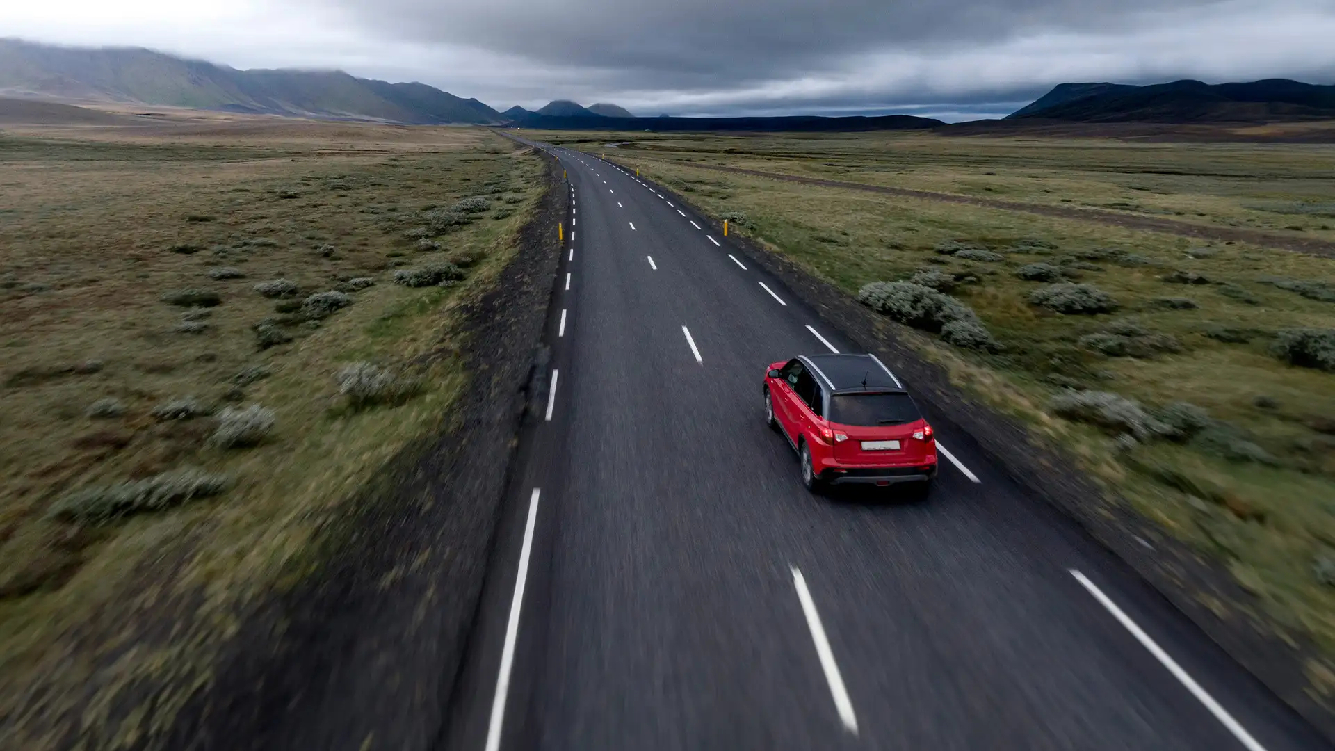 A Car driving down a long road