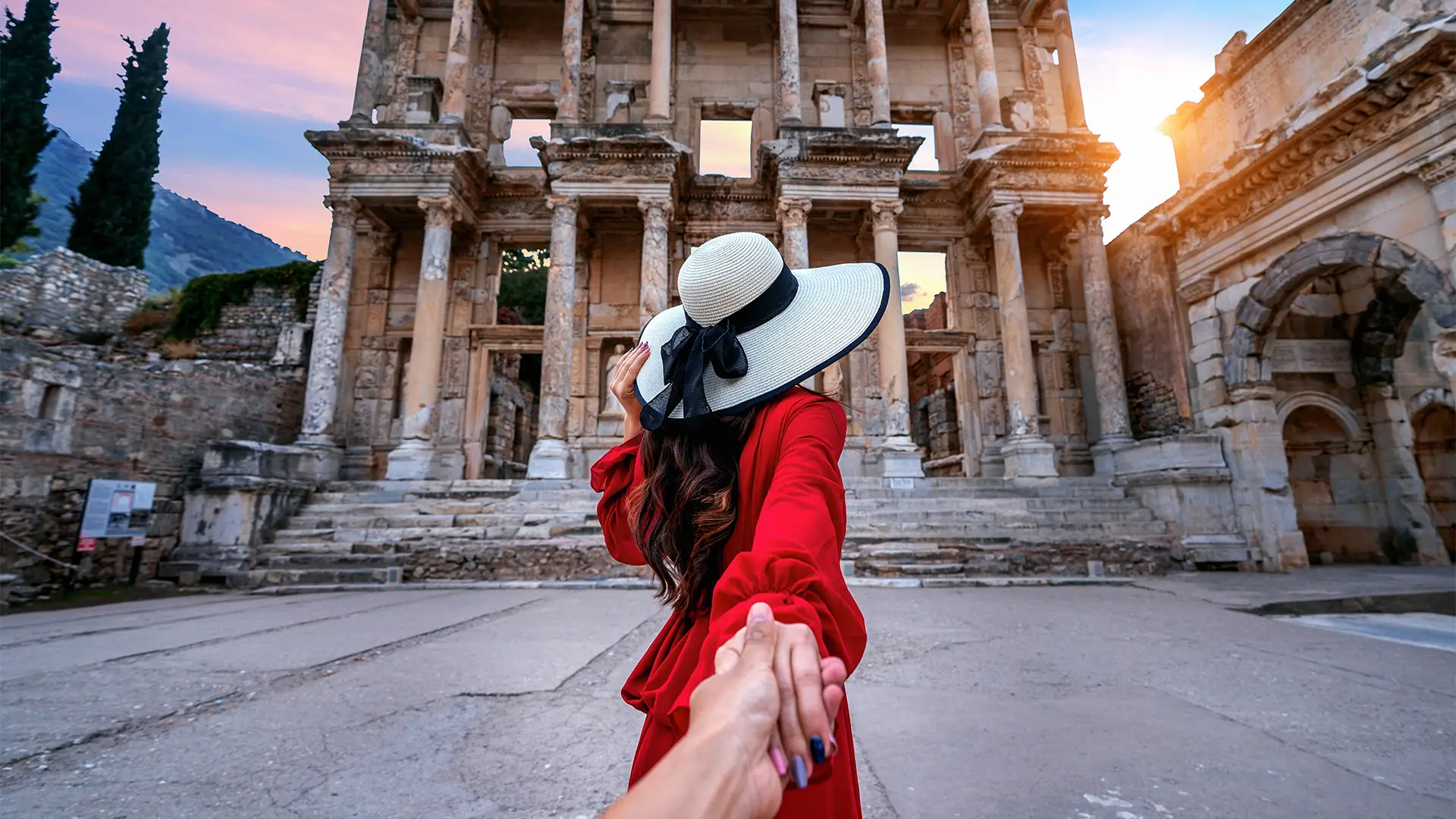 A Woman leading a man through ruins in Izmir